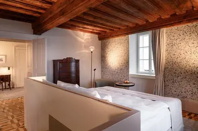 a bedroom with a large white bed in a room at Zlata Ladjica Boutique Hotel in Ljubljana