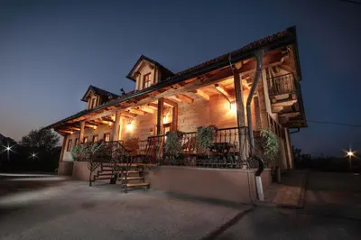 a building with a balcony with lights on it at Wine & Tourism Bračko in Jakobski Dol
