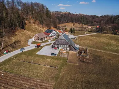 an aerial view of a house on a hill at Wooden Cabin Zurej with Hot Tub in Bukovje v Babni Gori