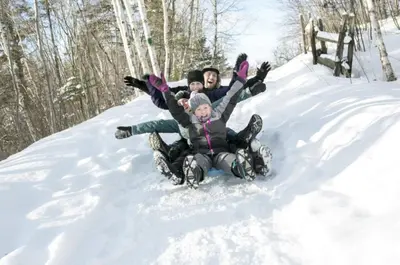 a group of people laying in the snow at Emerald Valley Apartments in Bovec