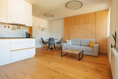 a living room with a couch and a table at Emerald Valley Apartments in Bovec