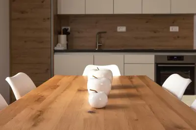 a vase sitting on a wooden table in a kitchen at HIŠA KOSOBRIN in Kranjska Gora