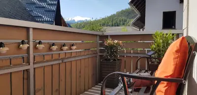 a balcony with a wooden fence and a chair at 7 LAKES apartment in Bohinj