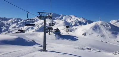 a ski lift on top of a snow covered mountain at 7 LAKES apartment in Bohinj