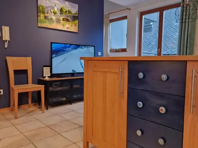 a living room with a dresser and a flat screen tv at 7 LAKES apartment in Bohinj