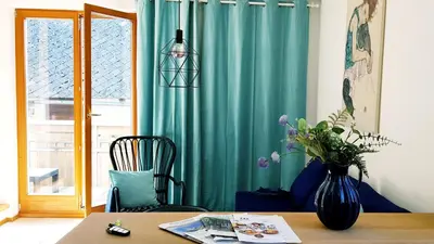 a room with a table and a vase of flowers at 7 LAKES apartment in Bohinj