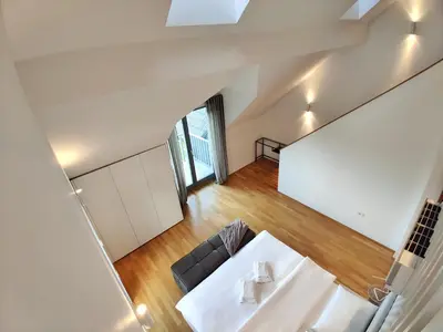 a room with a white table and a couch at Villa Recica North in Bled