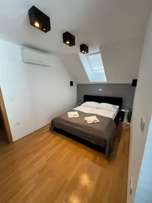 a bedroom with a bed with two towels on it at Villa Recica North in Bled