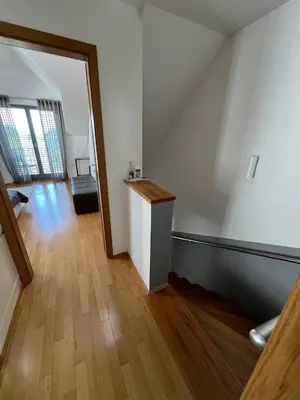 an empty room with a hallway with a wooden floor at Villa Recica North in Bled