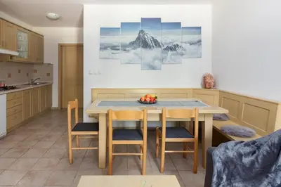 a kitchen with a table and chairs in a room at Peaceful Rogla Apartment in Zreče