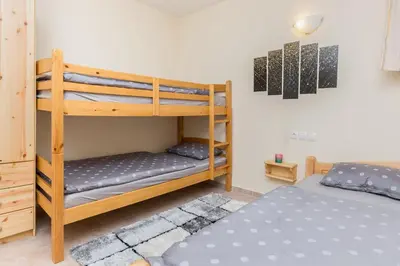 a bedroom with two bunk beds and a bed at Peaceful Rogla Apartment in Zreče