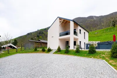 a house on a hill with a driveway at Hiša Kragelj in Most na Soči