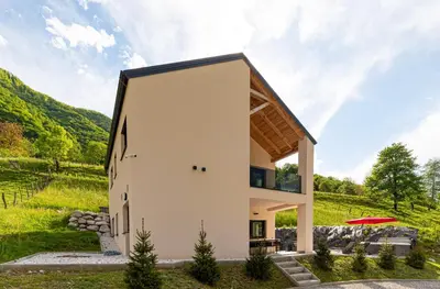 a house in the middle of a field at Hiša Kragelj in Most na Soči