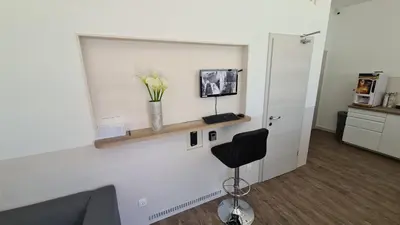 a room with a chair and a vase of flowers at Cabin HOSTEL in Ljubljana