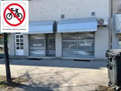 a no biking sign in front of a store at Cabin HOSTEL in Ljubljana