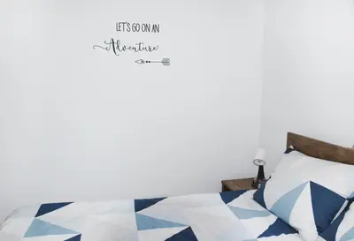 a bedroom with a bed with a blue and white quilt at M&M Apartment in Zgornje Gorje