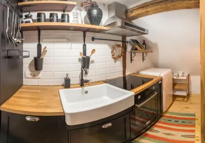 a kitchen with a sink and a stove at Apartment DOMI in Soča