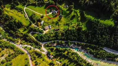 a house on a hill with a red circle on it at Apartment DOMI in Soča