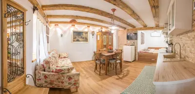 a living room with a couch and a table at Rustic Apartment PETRA in Soča