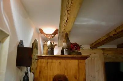 a light on top of a wooden shelf in a room at Rustic Apartment PETRA in Soča