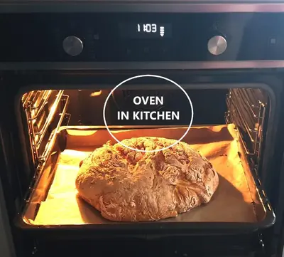 a loaf of bread is cooking in an oven at Golte SkiCenter App MOUNTAIN VIEW WITH BALCONY in Mozirje