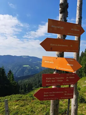 a sign on a mountain with arrows on it at Golte SkiCenter App MOUNTAIN VIEW WITH BALCONY in Mozirje