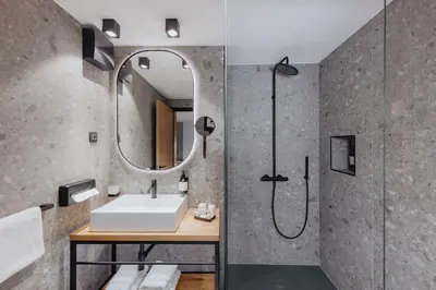 a bathroom with a sink and a shower at ONE66 Hotel in Ljubljana