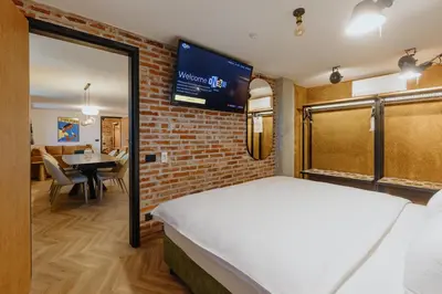 a bedroom with a bed and a brick wall at ONE66 Hotel in Ljubljana