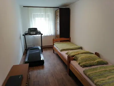 a room with three beds and a desk in it at Bela golobica Bogojina in Bogojina