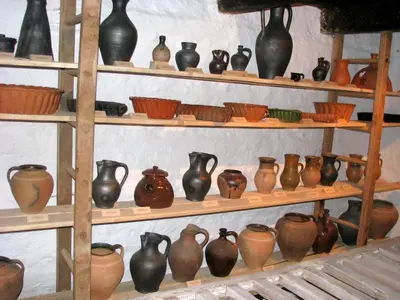 a bunch of vases on shelves in a room at Bela golobica Bogojina in Bogojina