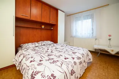 a bedroom with a large bed with a wooden headboard at Bela golobica Bogojina in Bogojina
