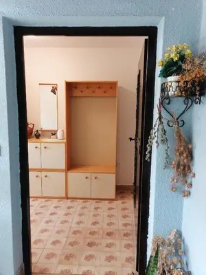 a doorway into a room with a dresser and a mirror at Bela golobica Bogojina in Bogojina
