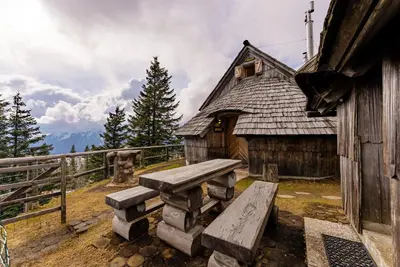 a wooden building with a bench in front of it at Alpine Chalet Velika Planina - Irenca - I Feel Alps in Stahovica