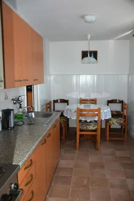 a kitchen with a table and some chairs and a table and a kitchen at Hiša v Travniku in Šmartno