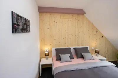 a bedroom with a bed with two tables and two lamps at Pr `Agotnik Apartments & Rooms Bohinj in Bohinj
