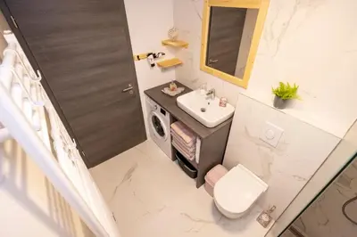 a small bathroom with a sink and a toilet at Pr `Agotnik Apartments & Rooms Bohinj in Bohinj