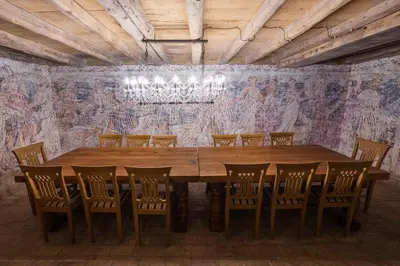 a dining room with a large wooden table and chairs at Villa Xaxat in Koper