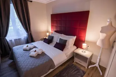a bedroom with a large bed with a red headboard at Villa Xaxat in Koper