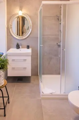 a bathroom with a shower and a sink and a mirror at Villa Xaxat in Koper