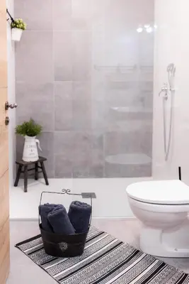 a bathroom with a toilet and a glass shower at Villa Xaxat in Koper