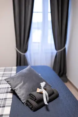 a ribbon on a pillow on a bed at Villa Xaxat in Koper