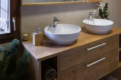 a bathroom with two sinks on a wooden counter at Chalet Neza Velika Planina in Stahovica