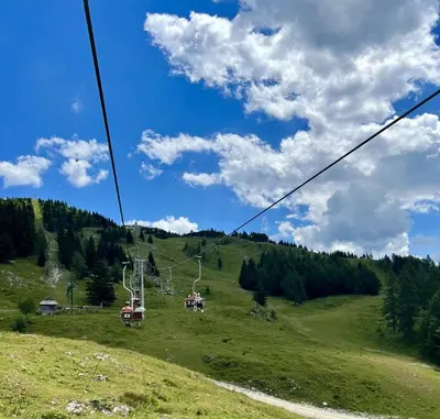 a gondola ride up a grassy hill at Chalet Neza Velika Planina in Stahovica