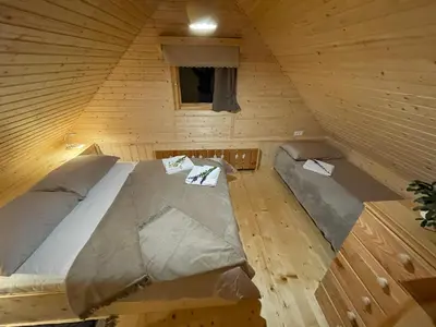 an overhead view of a bed in a wooden cabin at Miha`s cottage in Bohinj