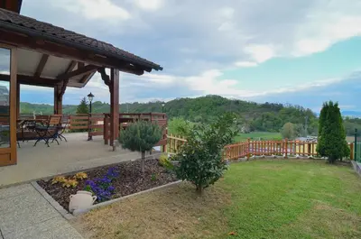 a yard with a pavilion and a garden with flowers at Flower house Podčetrtek in Podčetrtek