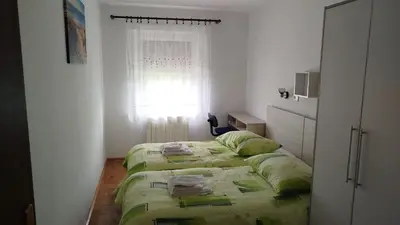 a bedroom with a bed and a window at Pri Stari murvi in Vogrsko