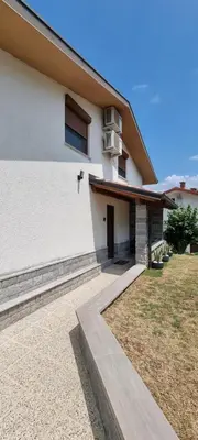 a white building with a door and a window at Pri Stari murvi in Vogrsko