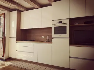 a kitchen with white cabinets and a microwave at Apartma Kras in Komen