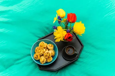 a plate of donuts and flowers on a table at Zelena dolina in Cerkno