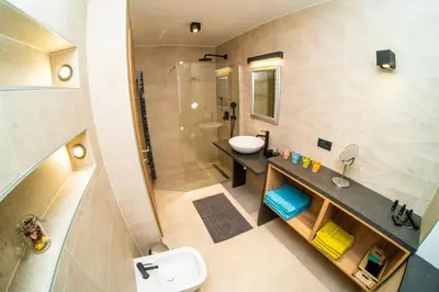 a bathroom with a sink and a toilet and a shower at Zelena dolina in Cerkno